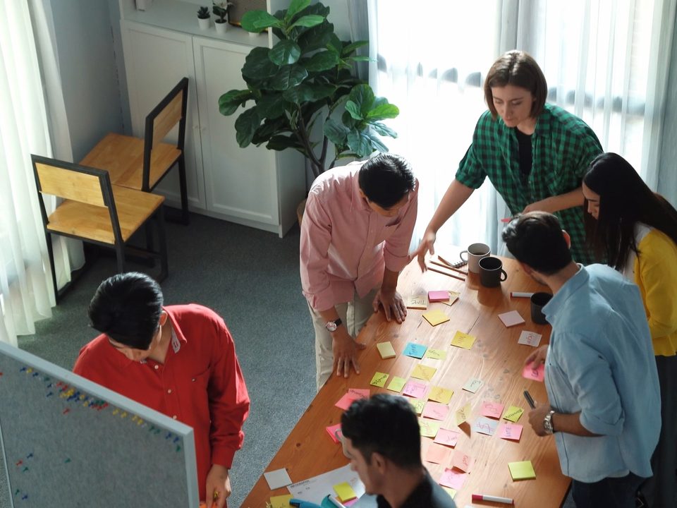 A team mapping ideas on sticky notes